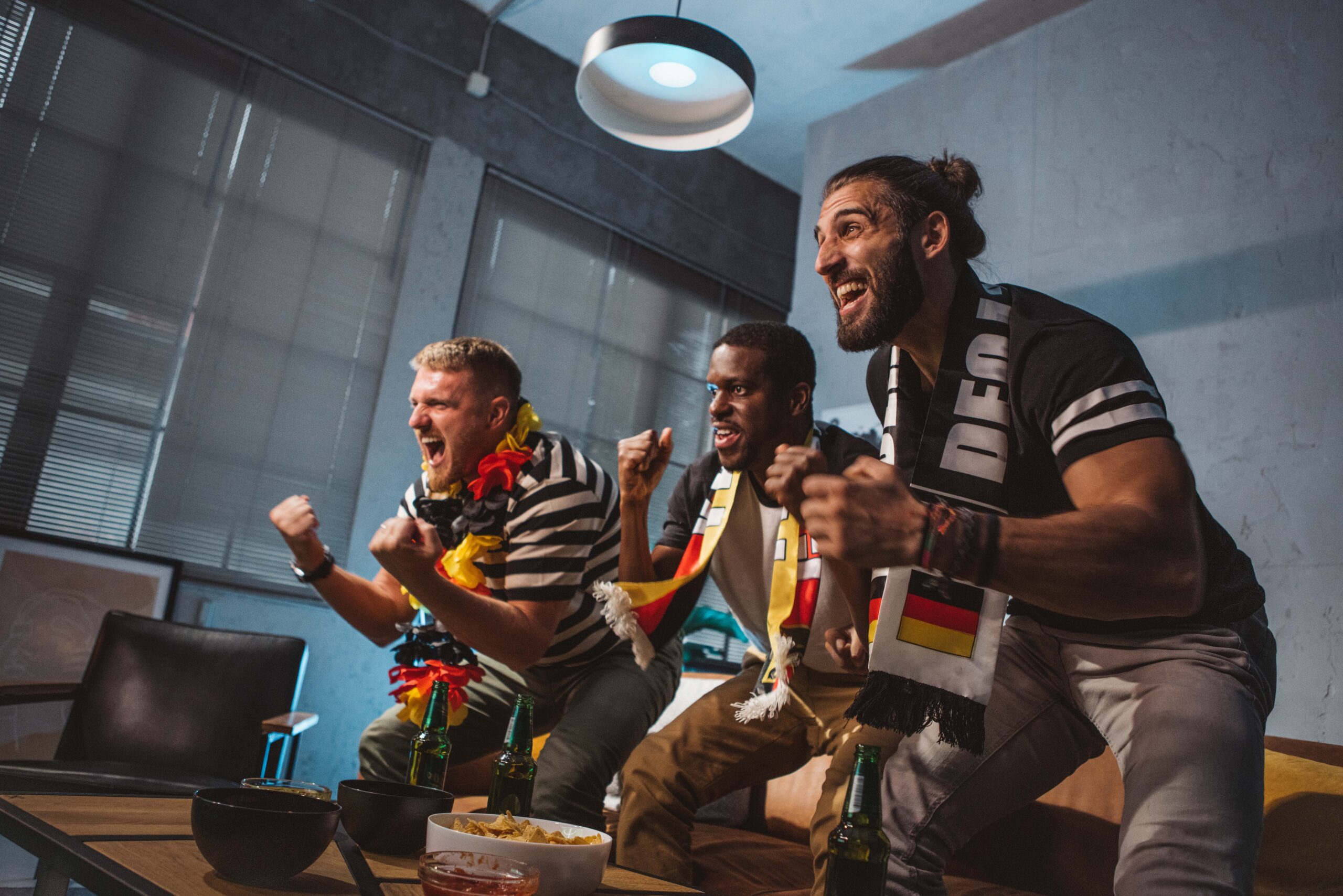 Friends watching soccer championship at home The BiG GiG Fiber Network Multi-GiG tv